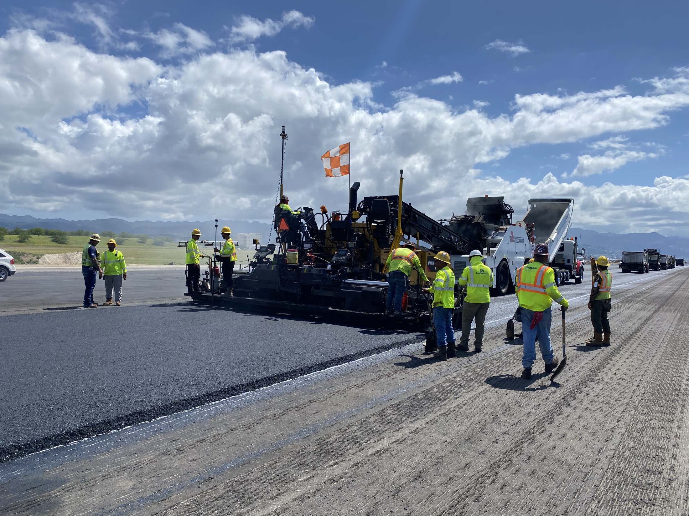 Grace Pacific crew paving a runway during the day